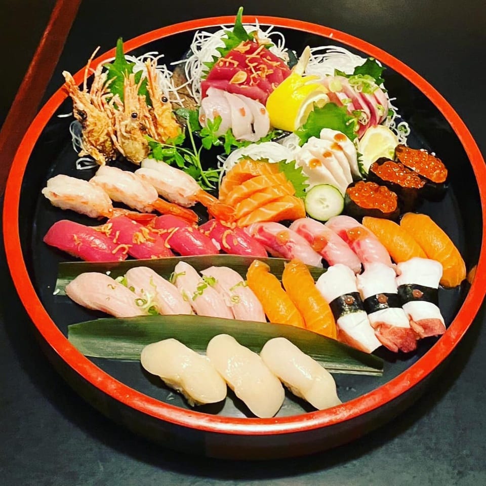 A large platter of Koiso Japanese Restaurant's assorted sushi and sashimi, including shrimp, tuna, and salmon.