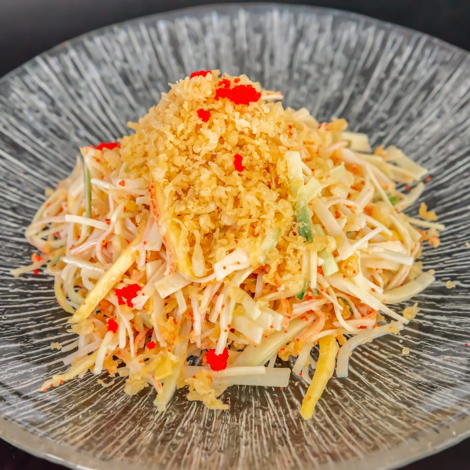 Koiso Japanese Restaurant's Kani Salad, a vibrant mix of shredded crab, tobiko, and crispy tempura flakes.