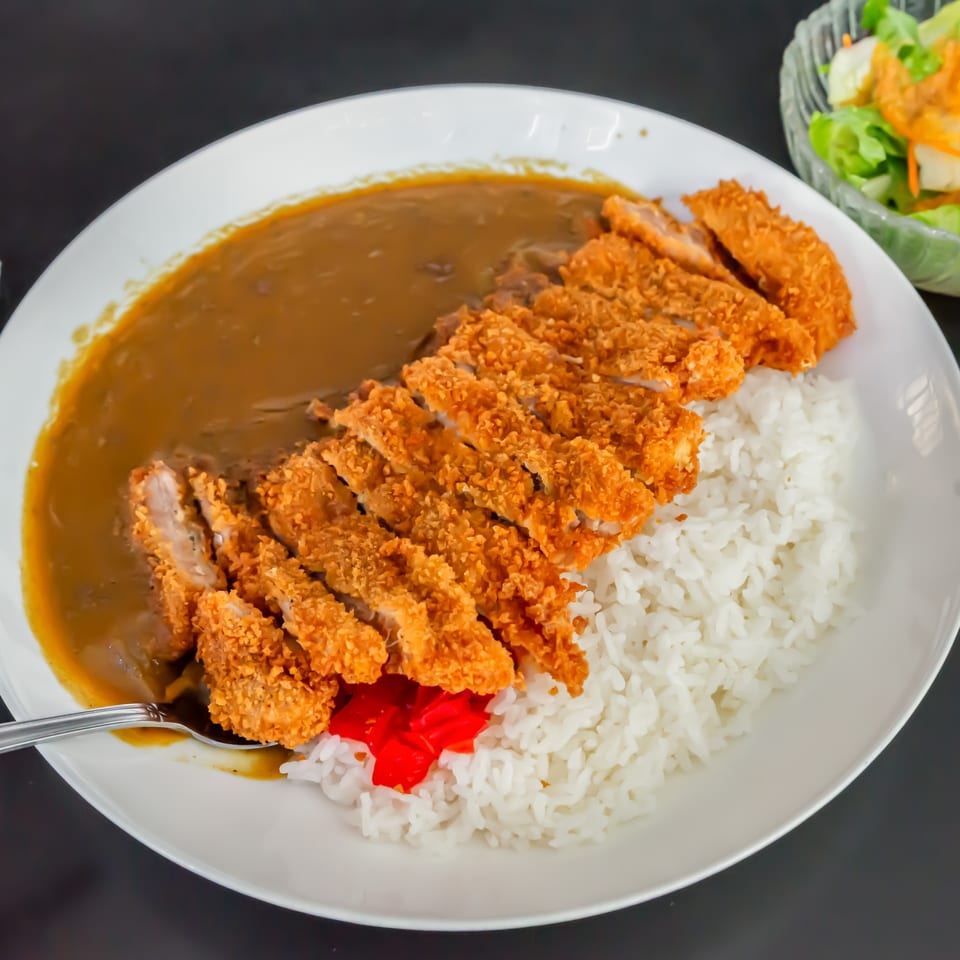 Koiso Japanese Restaurant's chicken katsu curry with rice and a side salad.